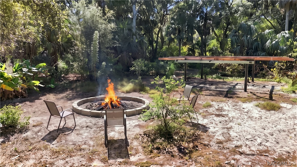 GATHER AROUND THE FIRE! A circular FIRE PIT AREA surrounded by seating offers an inviting spot for evening conversations, roasting marshmallows & enjoying the outdoors.