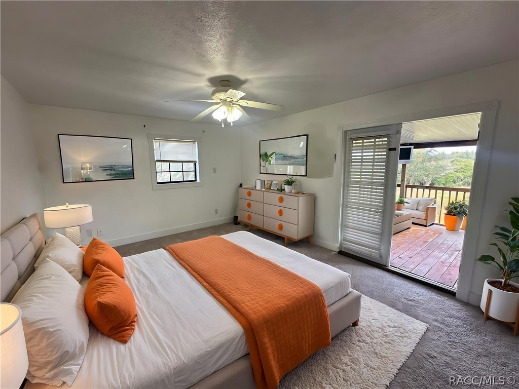 Master bedroom with door to back deck (virtually staged)