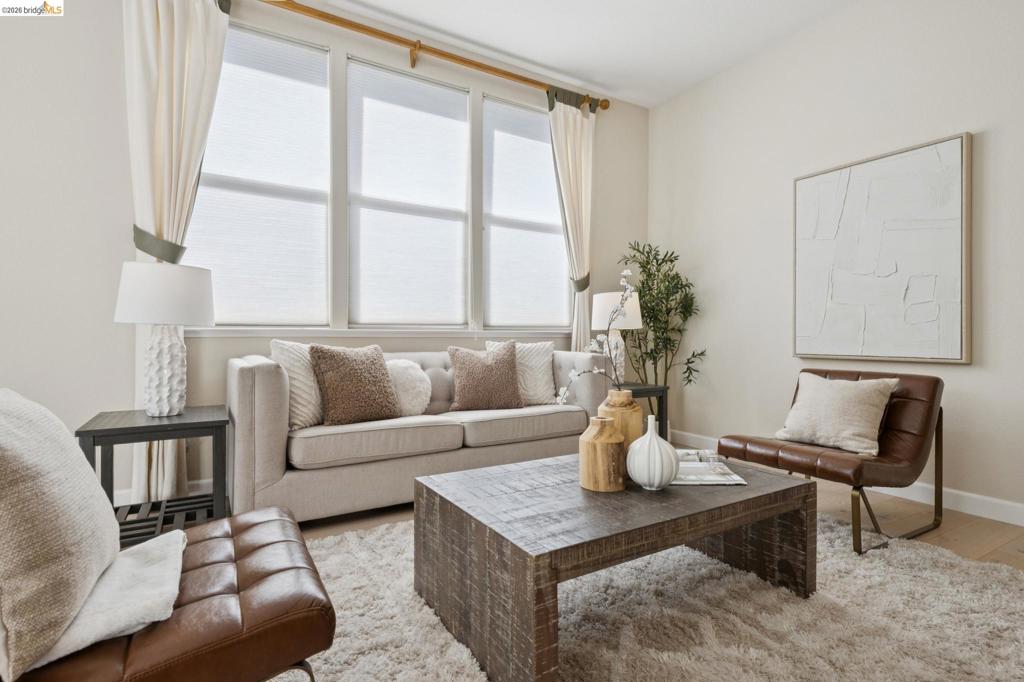 Triple-pane window configuration with neutral-toned walls and wood-finish flooring