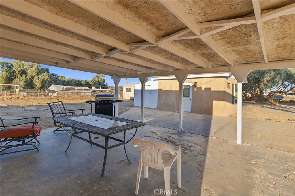 Covered patio with finished workshop in the distance