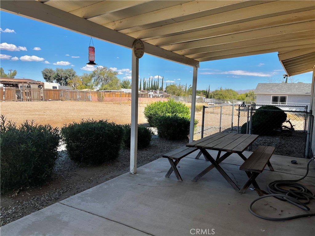Backyard patio area with small dog run.