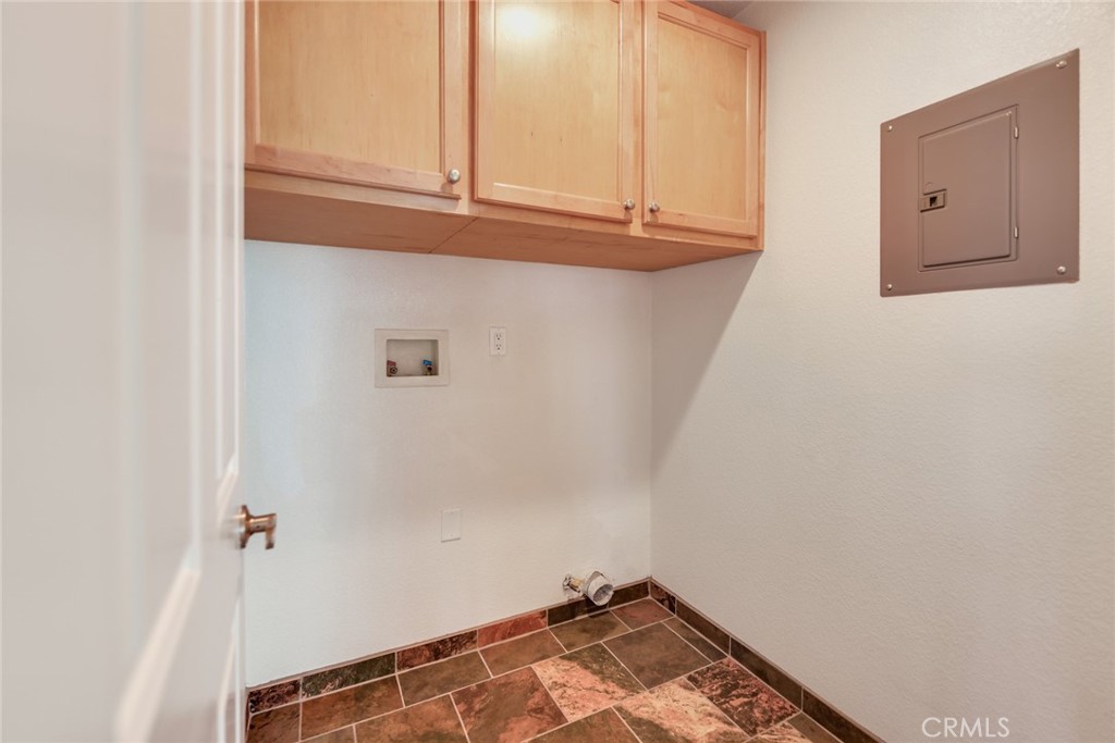 Upstairs tiled laundry room w/extra storage