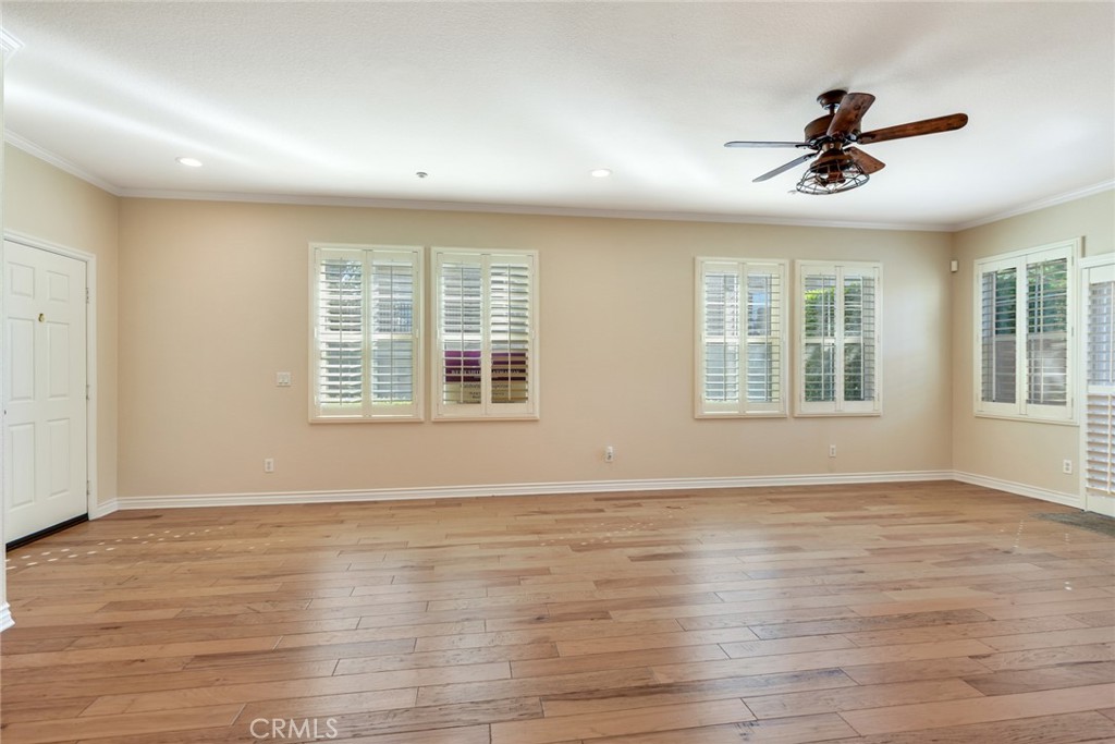 Downstairs great room w/Plantation Shutters and wood floors
