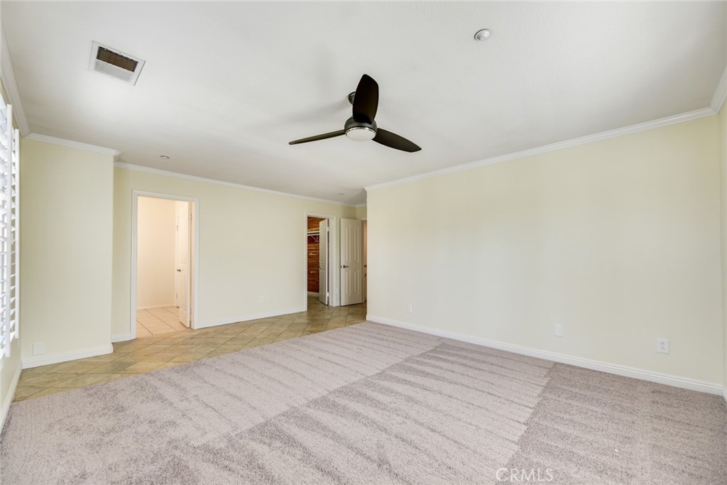 Primary bedroom w/ walk-in closet and ensuite bath