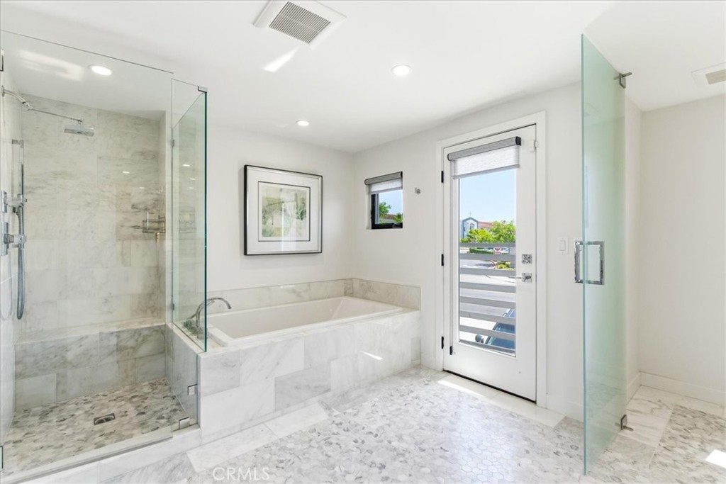 Primary bath with a walk-in shower and soaking tub.