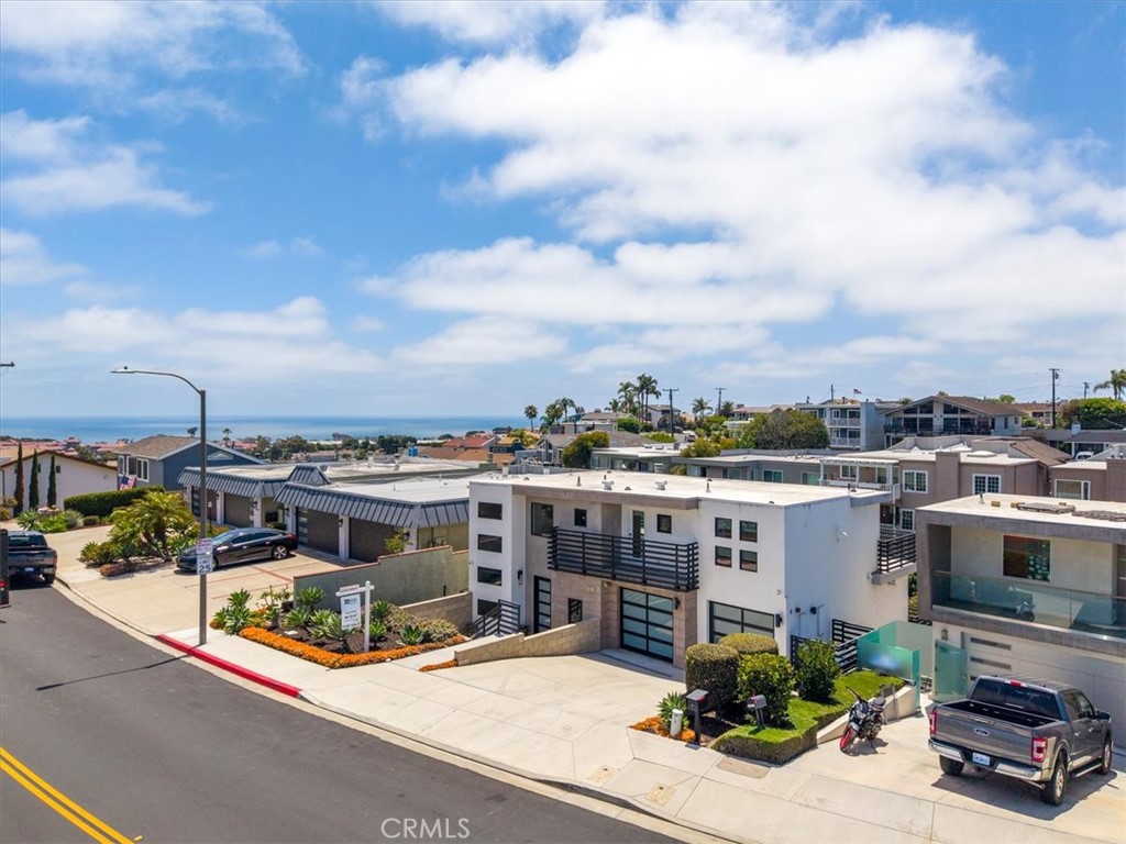 Aerial view of the neighborhood with the coast beyond.
