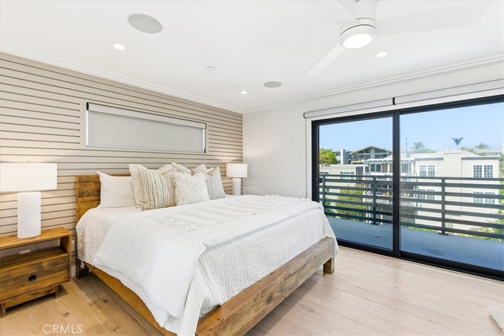 Bedroom with sliding glass doors to a balcony.