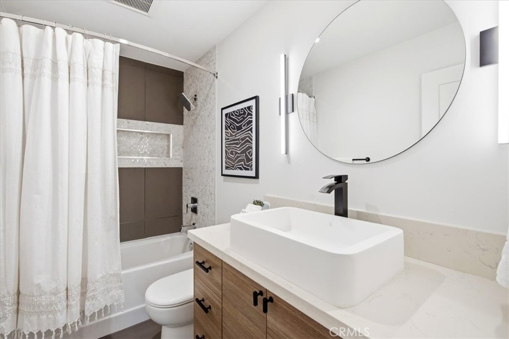 Bathroom with a vessel sink and shower curtain.