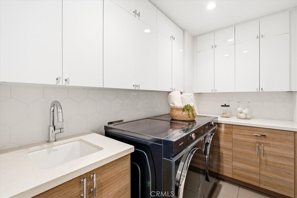 Laundry area with built-in cabinets and a sink.