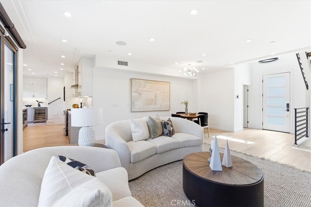 Open living room with a sectional and natural light.