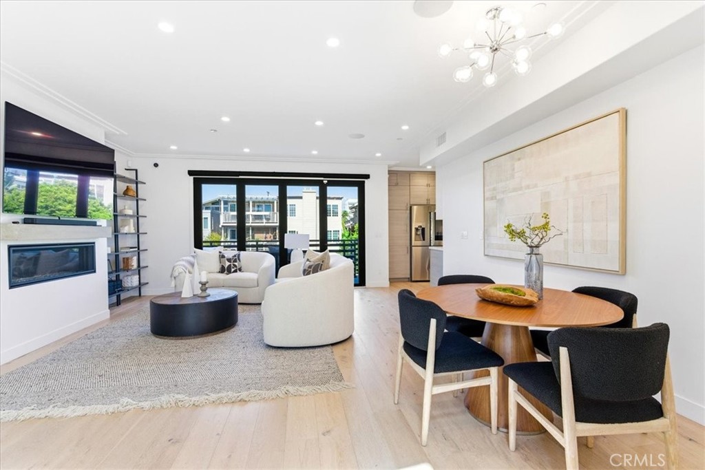 Living and dining area with a fireplace and large windows.