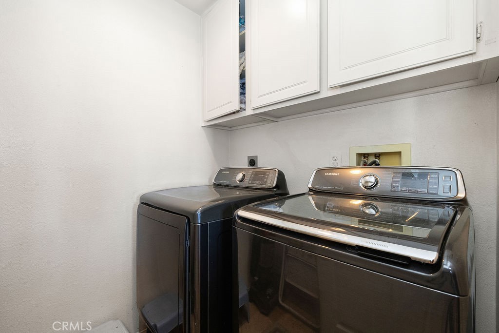Laundry Room With Sink, Counter Space and Cabinets