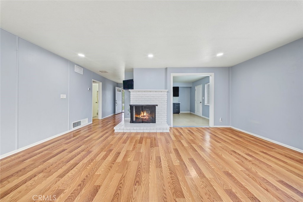 Living room is spacious and has a gas fireplace.