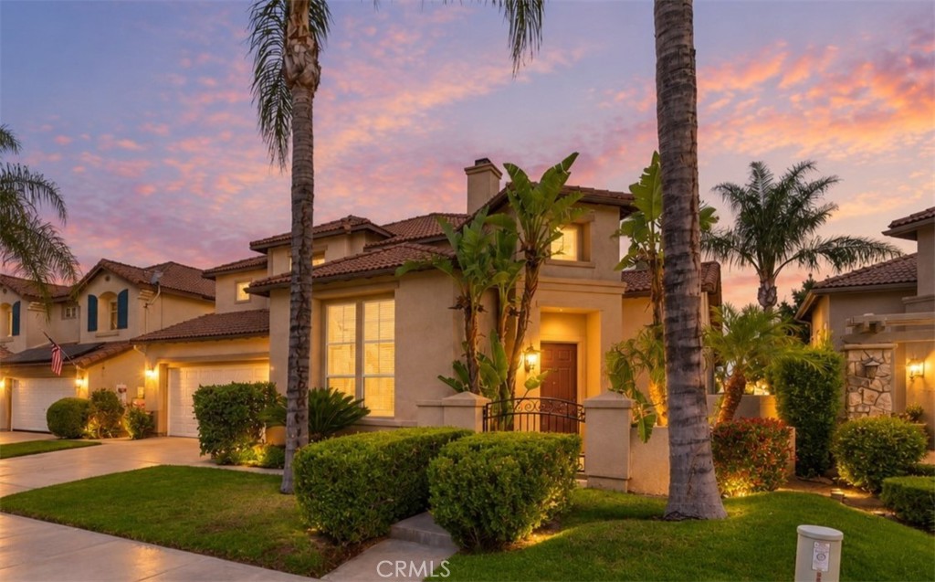 Attractive Exterior Showcasing The Home's Architectural Details, Lush Green Lawn, Mature Palm Trees, And Manicured Landscaping. Digitally Enhanced