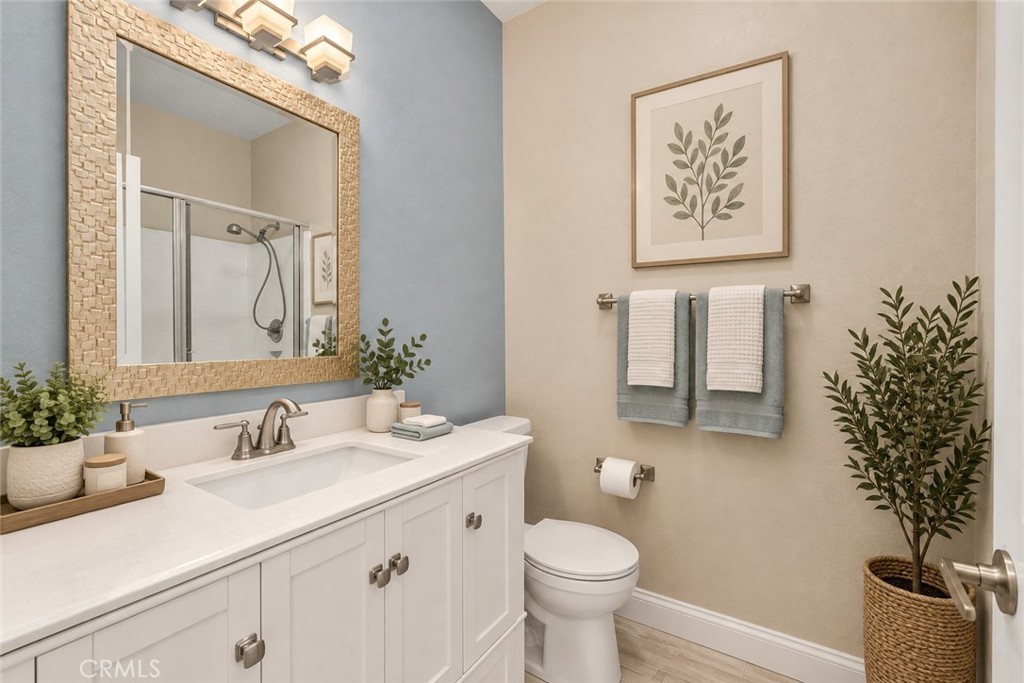 Well-Appointed Bathroom Featuring A White Vanity, Framed Mirror, Tub And Shower Combination, And Attractive Accent Wall. Digitally Staged