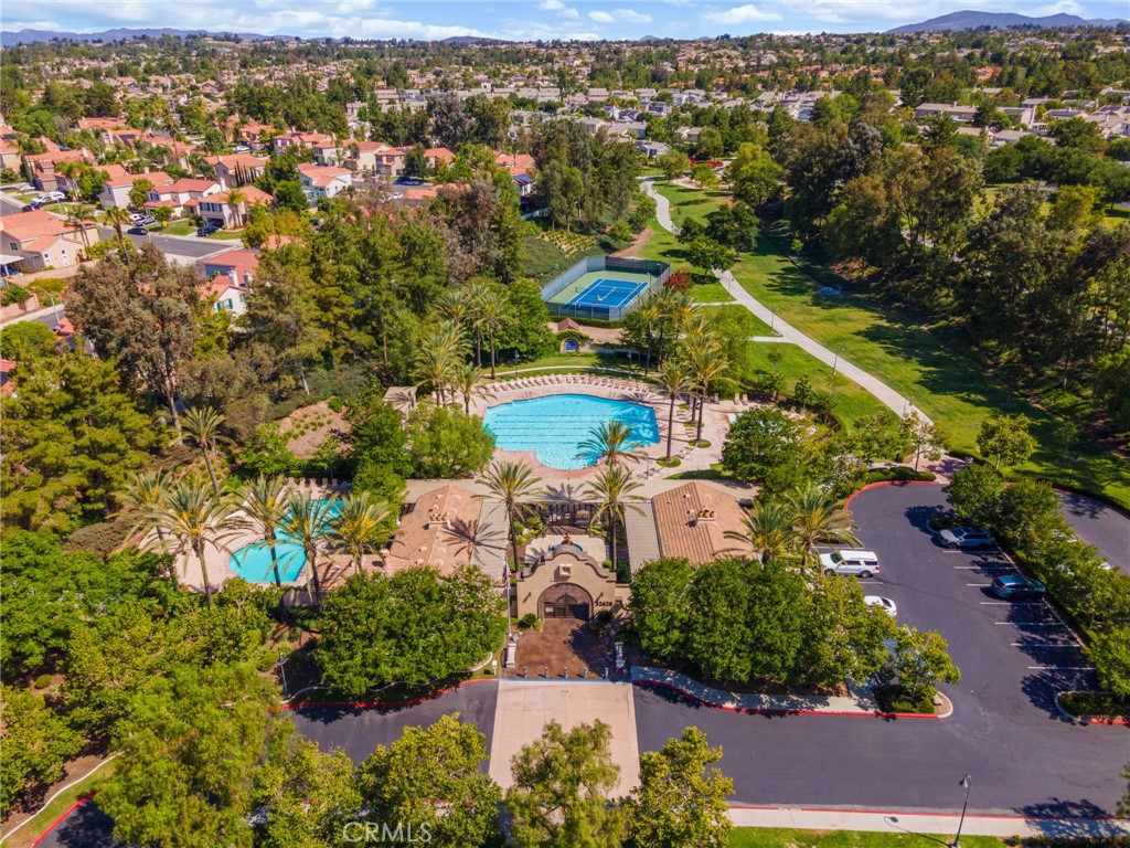 Aerial View Of The Beautiful Paseo Del Sol Community Amenities Featuring Resort-Style Swimming Pools, Recreational Courts, Walking Trails, And Expansive Green Spaces.
