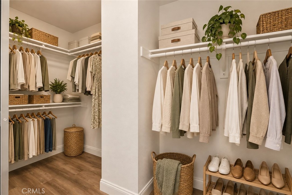 Generous Walk-In Closet Featuring Built-In Shelving, Multiple Hanging Areas, And Plenty Of Space For Clothing, Shoes, And Accessories. Digitally Staged