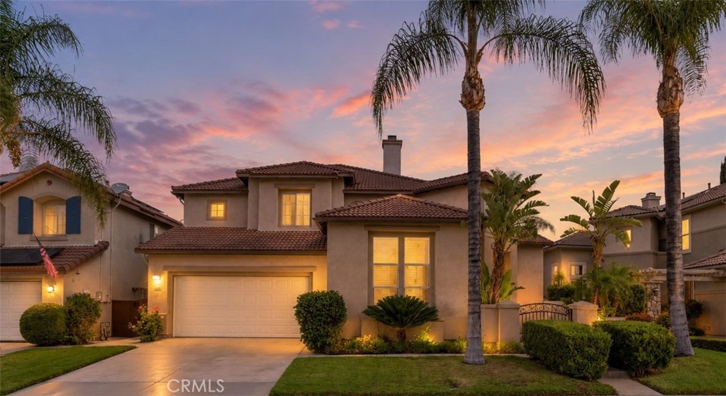 Beautiful Two-Story Home Featuring Attractive Curb Appeal, A Two-Car Garage, Mature Palm Trees, And Beautifully Maintained Landscaping. Digitally Enhanced