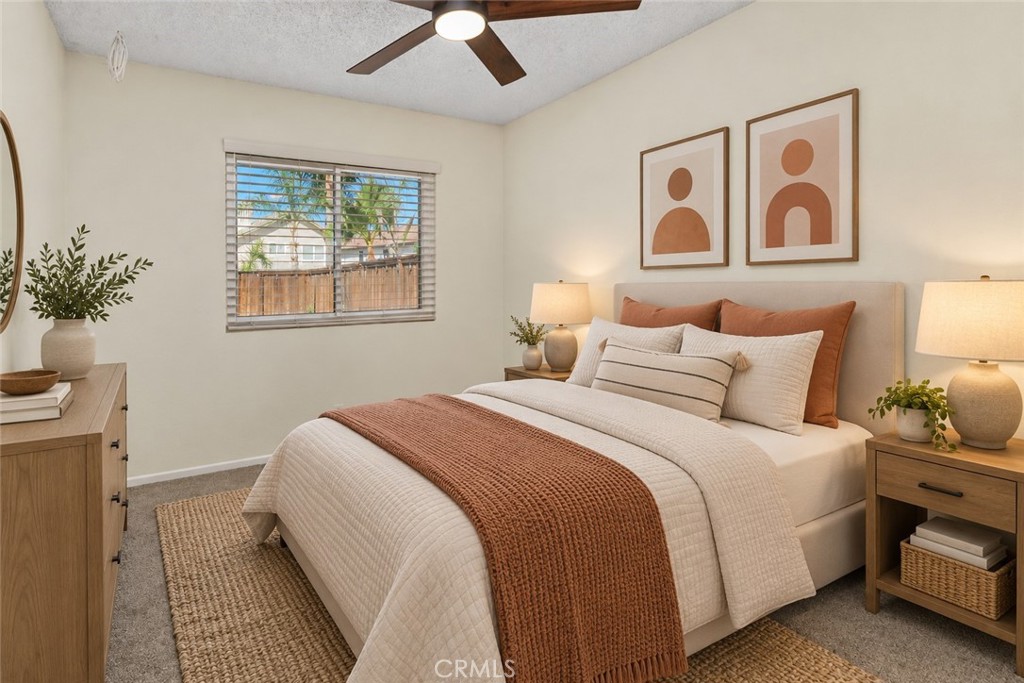 Another comfortable secondary bedroom featuring carpeted flooring, a ceiling fan, and natural light, with flexibility for guests, hobbies, or a home office. Digitally Staged