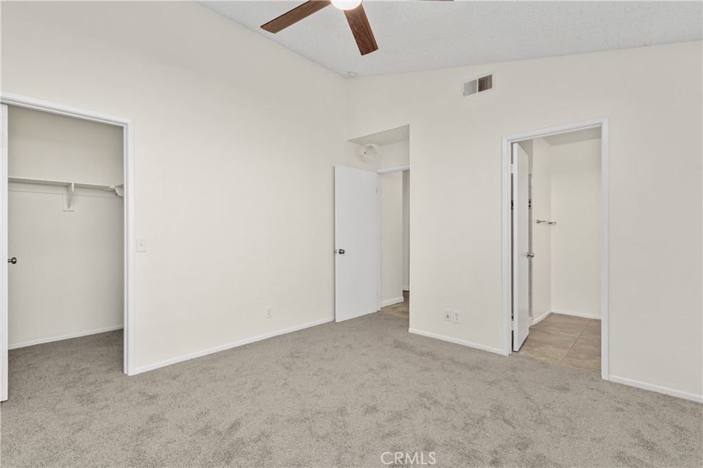 An additional view of the primary bedroom highlights the closet, comfortable layout, and convenient access to the adjoining bathroom.