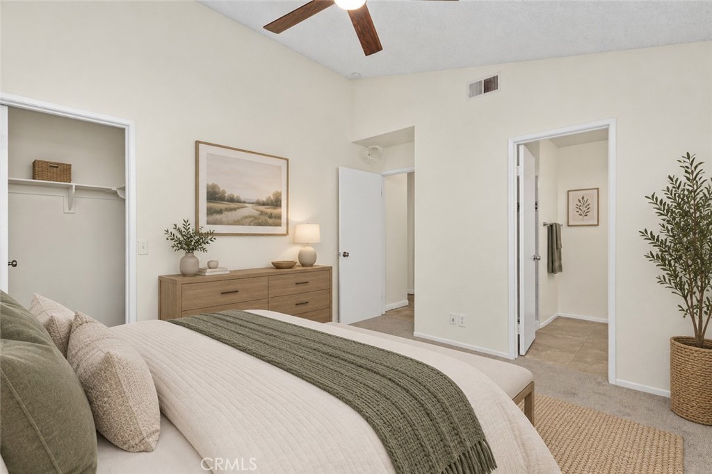 An additional view of the primary bedroom highlights the closet, comfortable layout, and convenient access to the adjoining bathroom. Digitally Staged