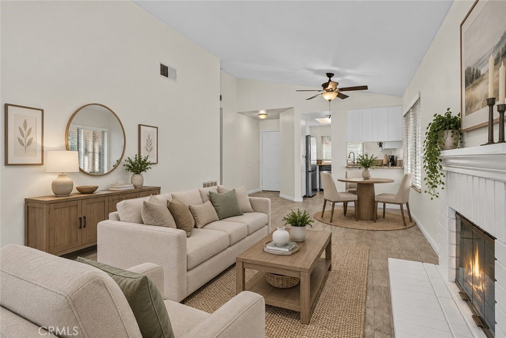 Another perspective of the living area highlights the open flow toward the dining space and kitchen, creating a comfortable setting for everyday living. Digitally Staged