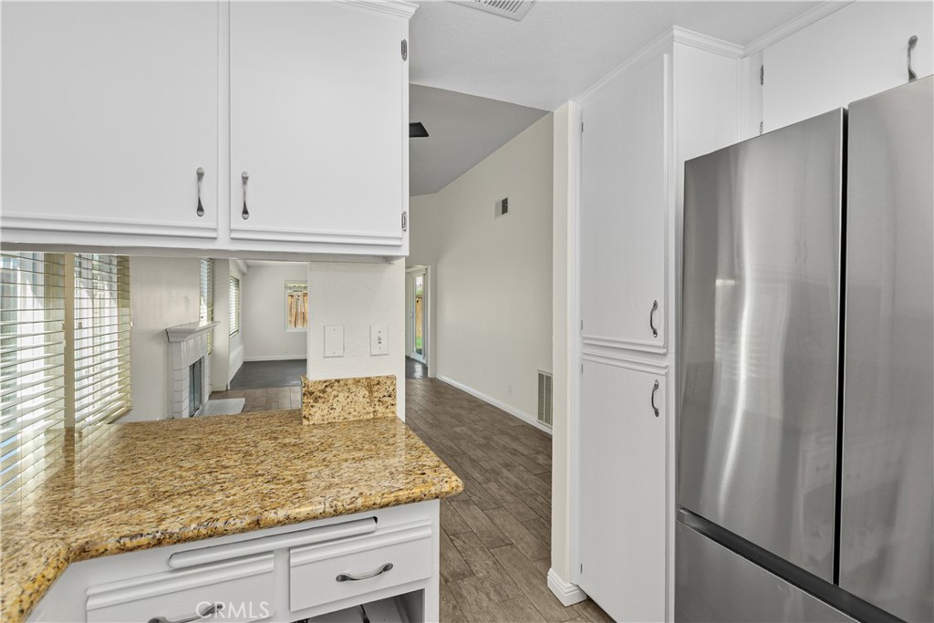 A view from the kitchen toward the living area showcases the home's open layout and convenient connection between the main gathering spaces.