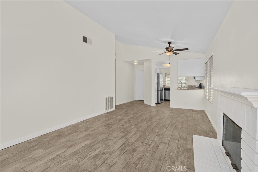 Another perspective of the living area highlights the open flow toward the dining space and kitchen, creating a comfortable setting for everyday living.