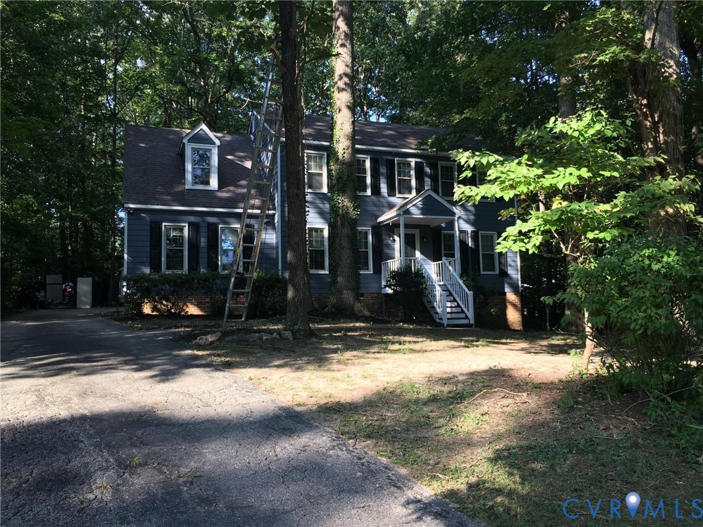 Colonial inspired home featuring driveway Colonial inspired home featuring driveway