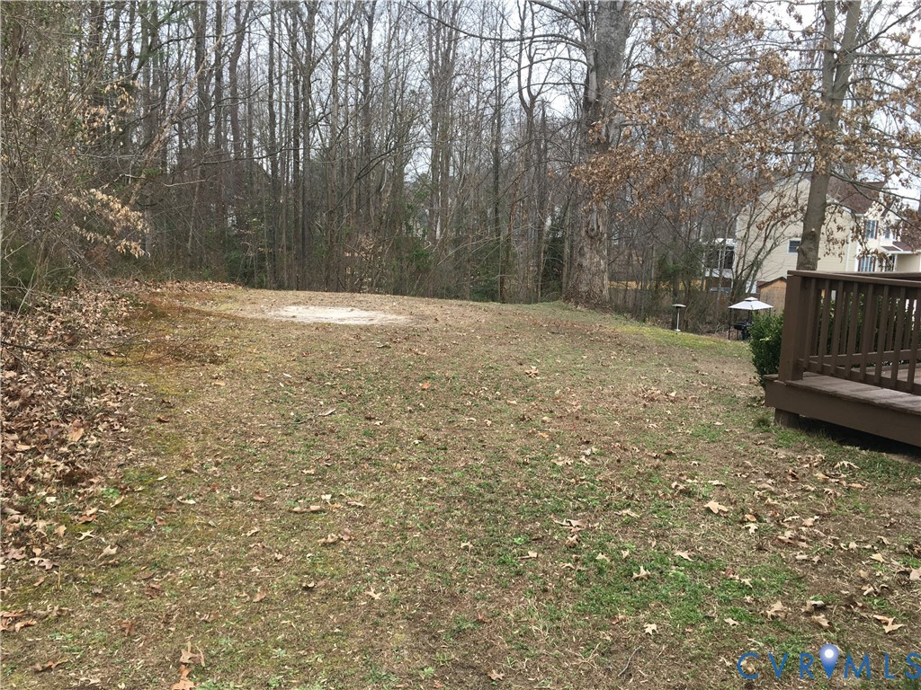 View of yard with a wooden deck