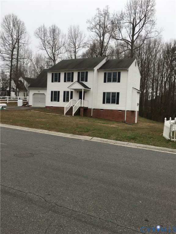 View of front of property featuring crawl space, a front lawn, and a garage View of front of property featuring crawl space, a front lawn, and a garage