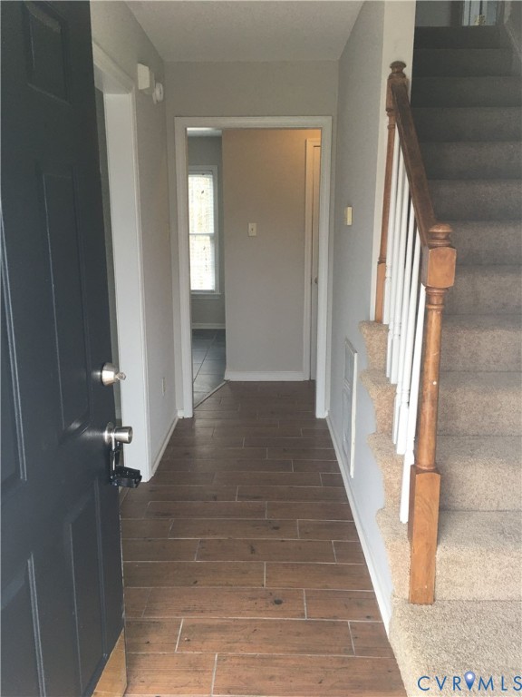 Foyer with wood tiled floors and stairs