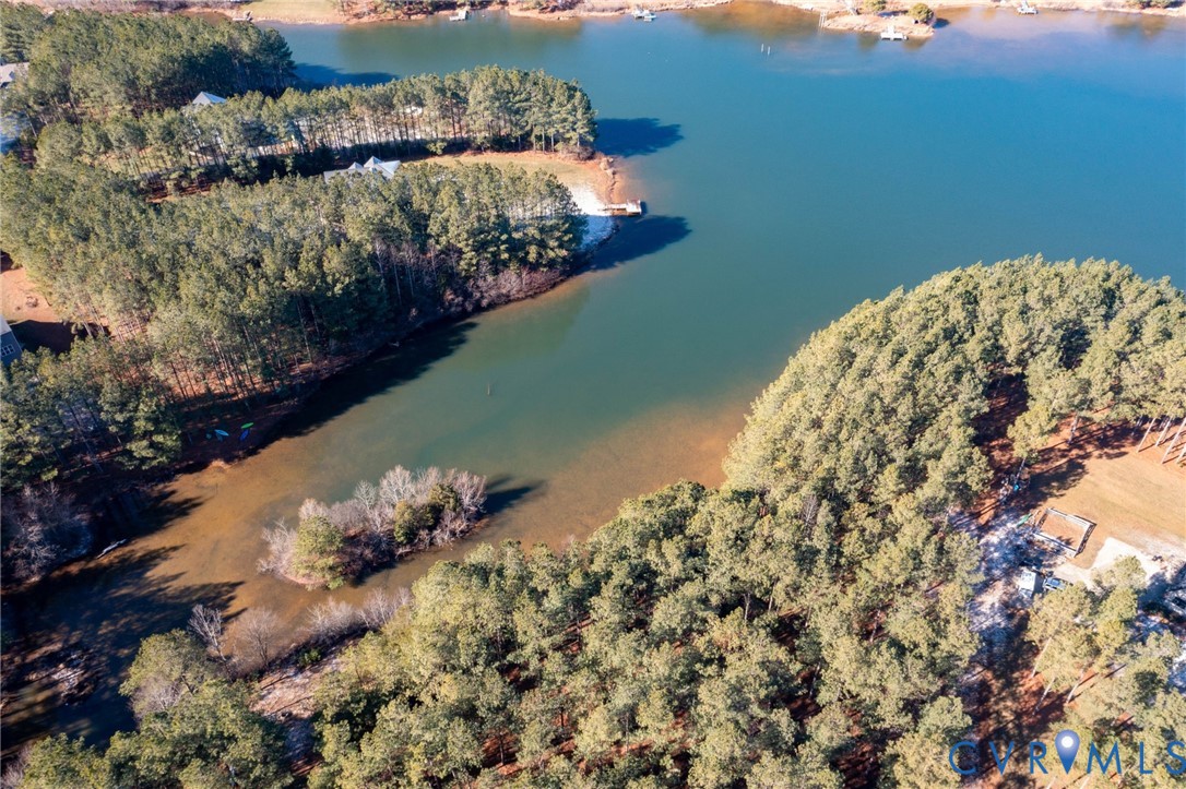 Aerial view of property and surrounding area featuring a large body of water