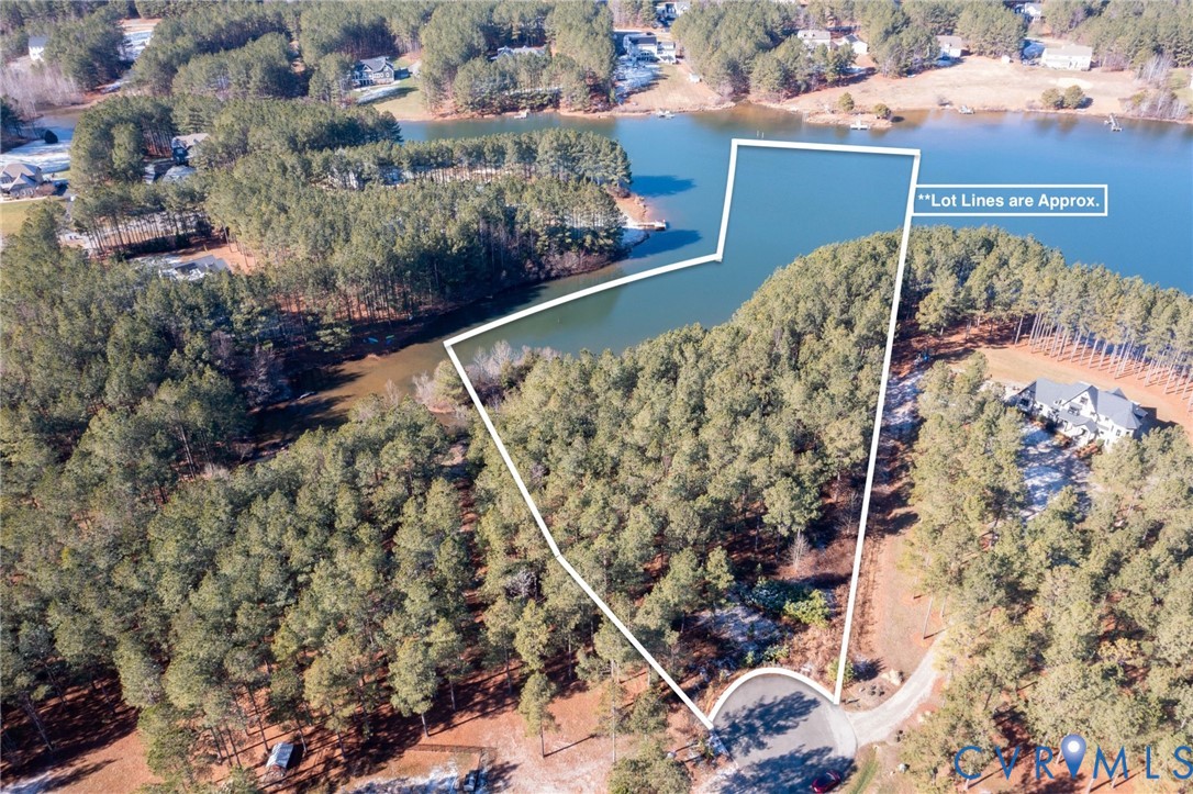 Aerial view of property and surrounding area with a large body of water and property parcel outlined Aerial view of property and surrounding area with a large body of water and property parcel outlined