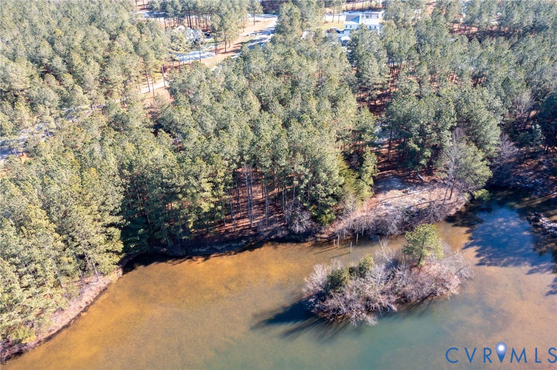 Aerial view of property's location with a large body of water