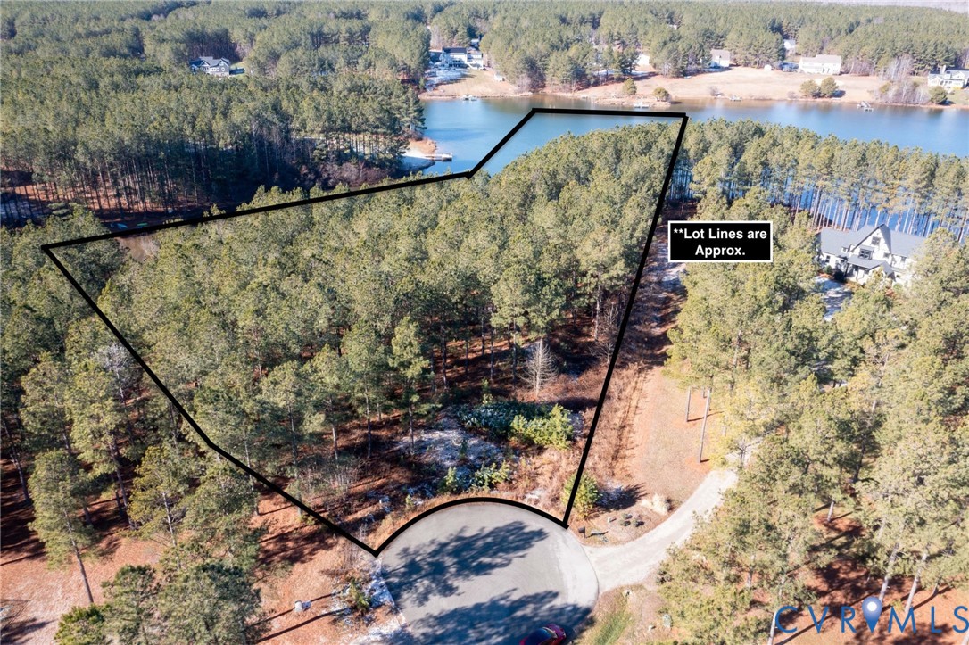 Aerial view of property's location with a large body of water and property parcel outlined