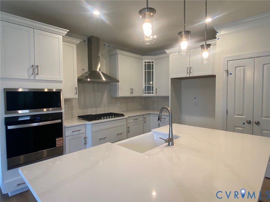 Whirlpool SS appliances.  Quartz countertops; White farmhouse sink.