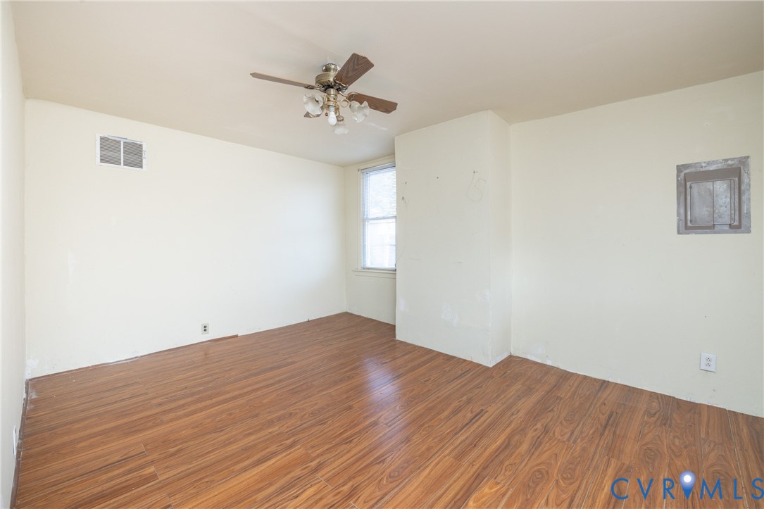 Empty room featuring wood finished floors and ceiling fan Empty room featuring wood finished floors and ceiling fan