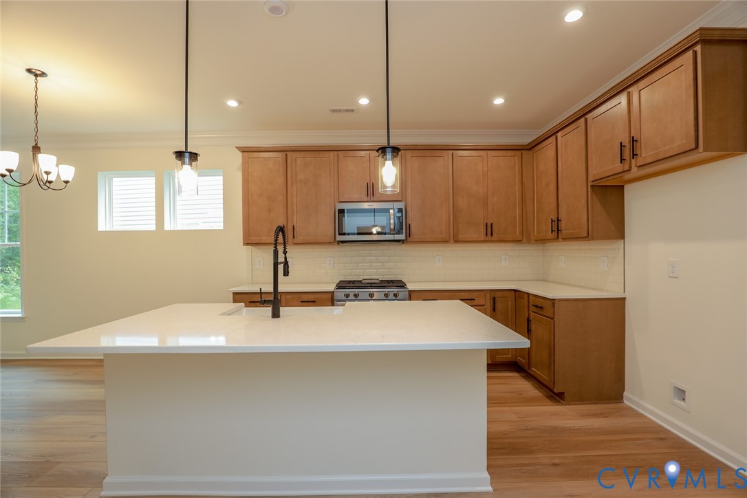 The photo represents the plan, not the actual home. Design selections may vary. This home features a kitchen with a large island that elevates the look and the walk-in pantry.