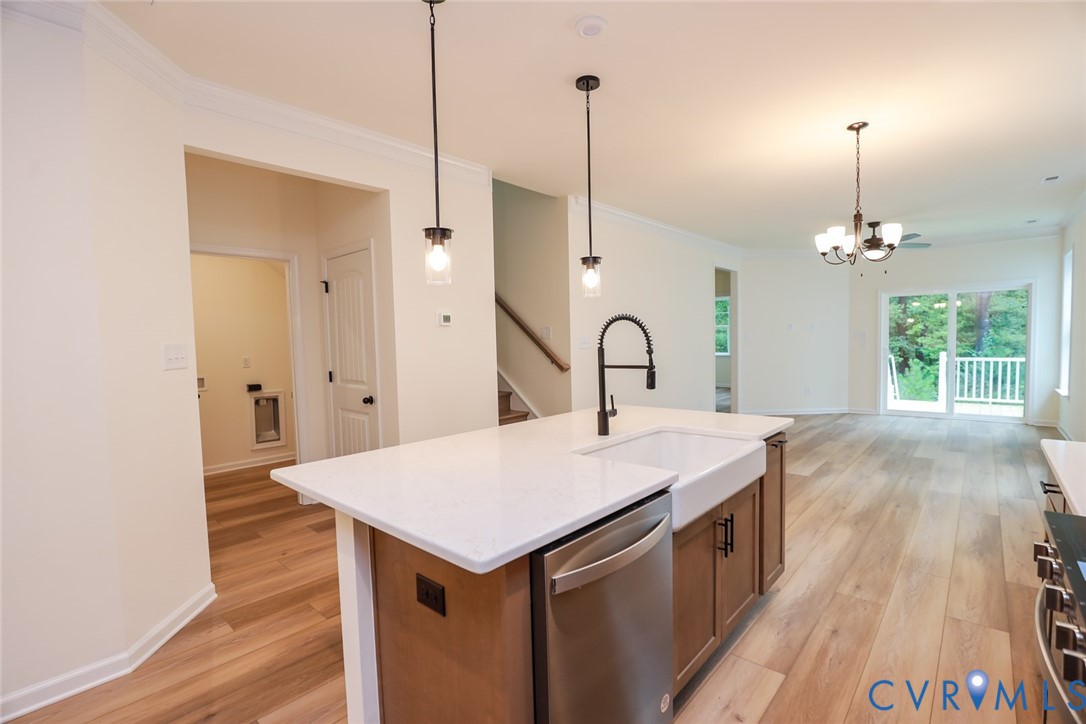 The photo represents the plan, not the actual home. Design selections may vary. This home features a kitchen with a large island that elevates the look and the walk-in pantry.