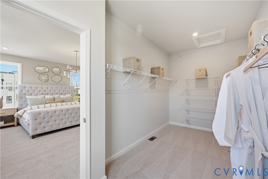 Walk-in closet with wire shelving and recessed lighting
