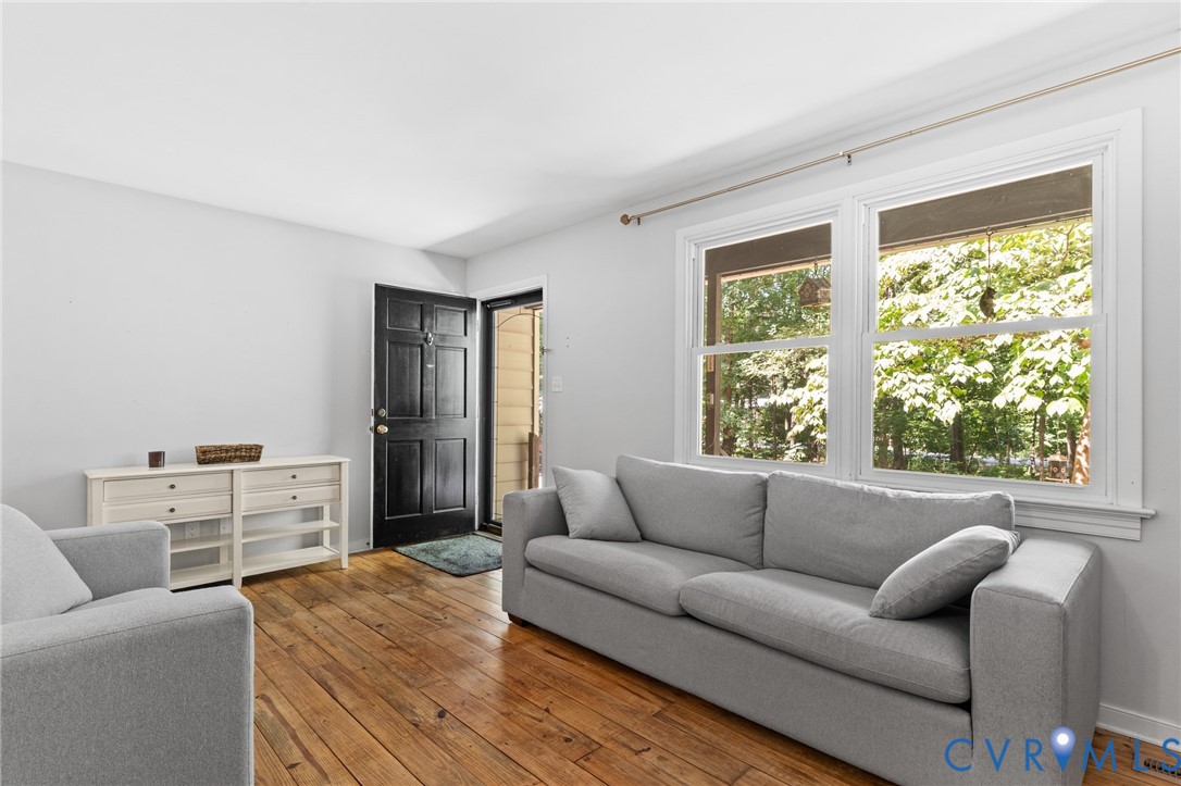 Family room with pine wood floors, neutral paint and lots of natural light