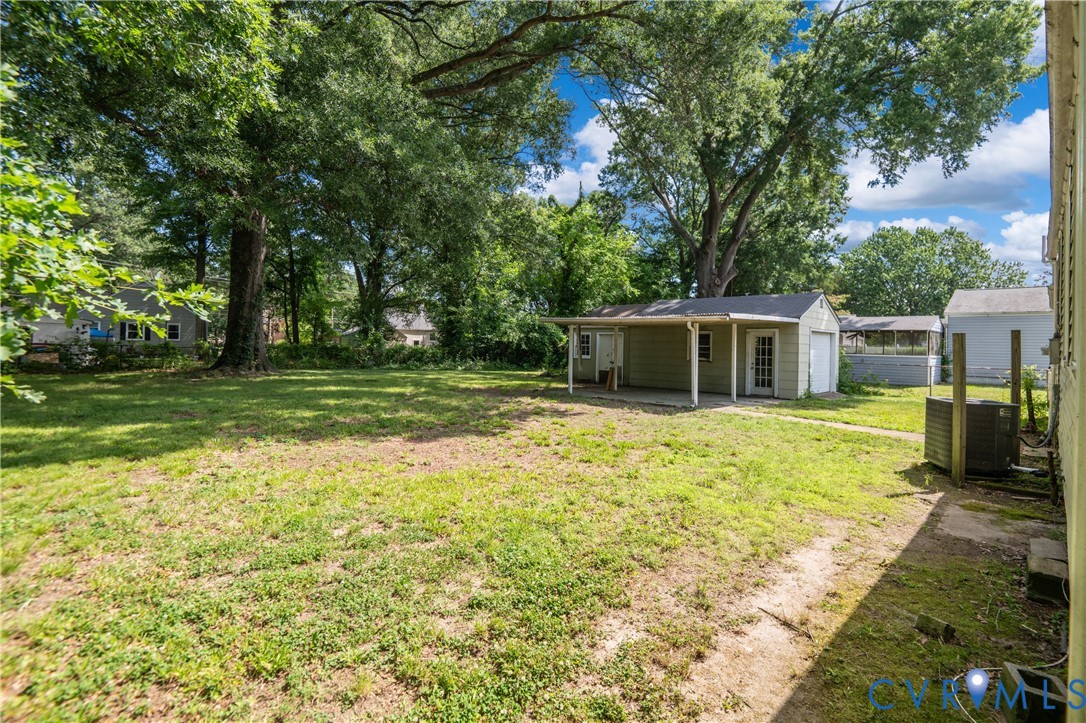 Fenced in back yard; side view of garage