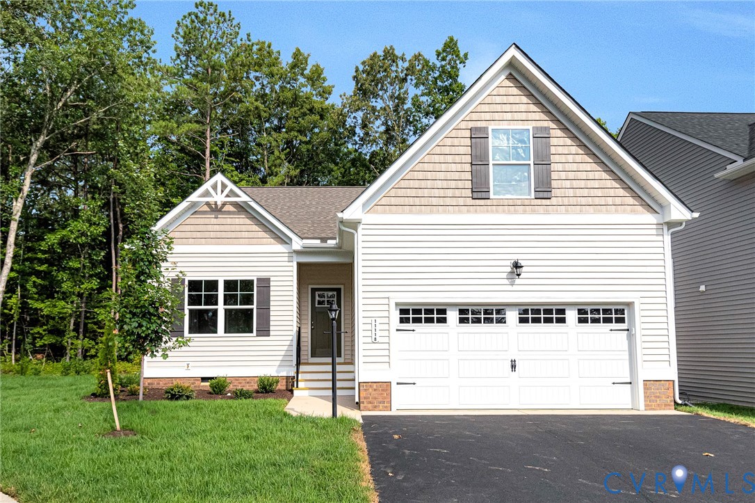 Contemporary home exterior featuring white siding, a shingled gable, and decorative shutters Contemporary home exterior featuring white siding, a shingled gable, and decorative shutters