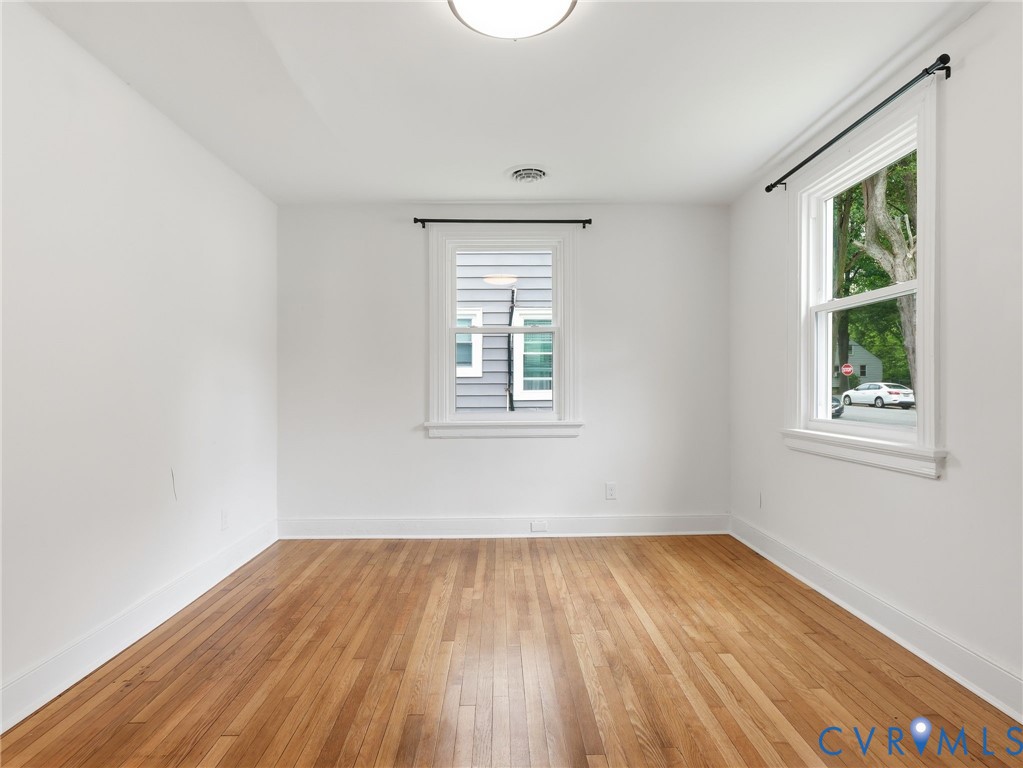Hardwood flooring spanning the room, complemented by white walls and trim