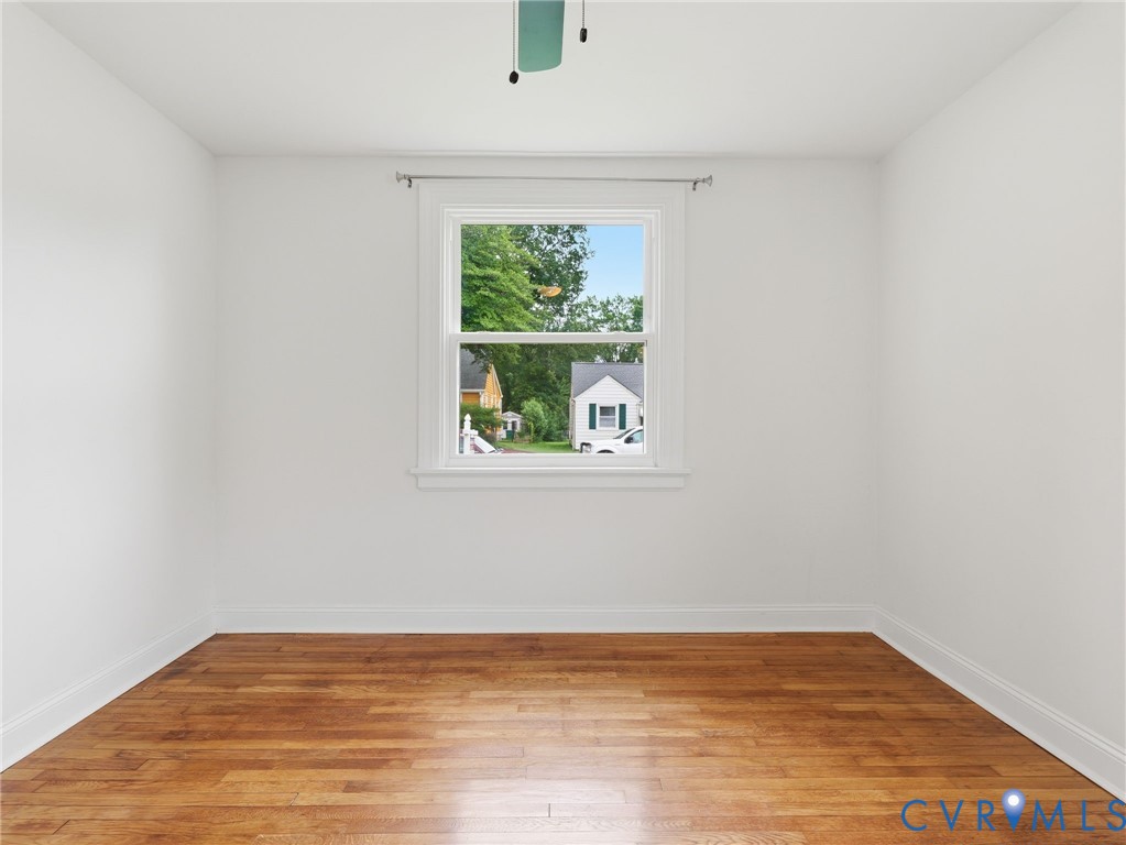 Room featuring light wood-finish flooring, white walls, and white trim Room featuring light wood-finish flooring, white walls, and white trim