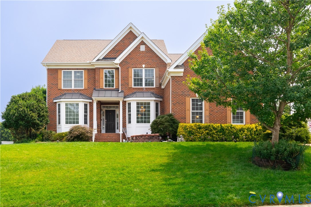 Brick exterior featuring multiple gables, bay windows, and wood-finish shutters Brick exterior featuring multiple gables, bay windows, and wood-finish shutters