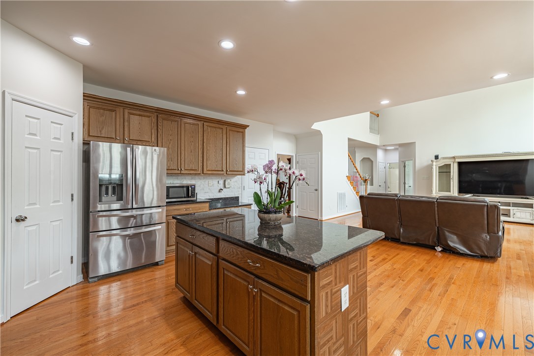 Kitchen island with a dark countertop and wood-finish cabinetry