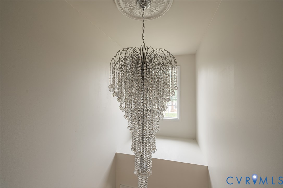 Tiered crystal chandelier with a decorative ceiling medallion