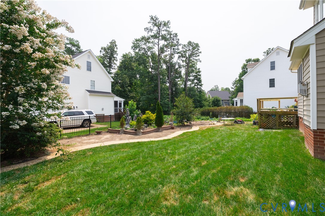 Expansive green lawn with a curved paved pathway